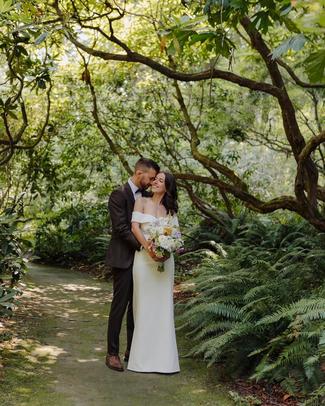 Couple taking wedding photos in a rhododendron garden